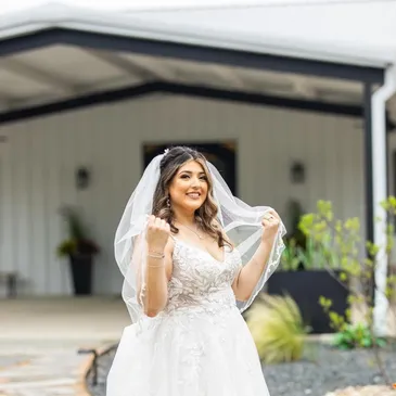 East Texas wedding venue. Bride posing in front of the wedding venue doors. Affordable wedding venue in Dallas.