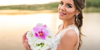Bridal portrait by a lake with a wedding bouquet.