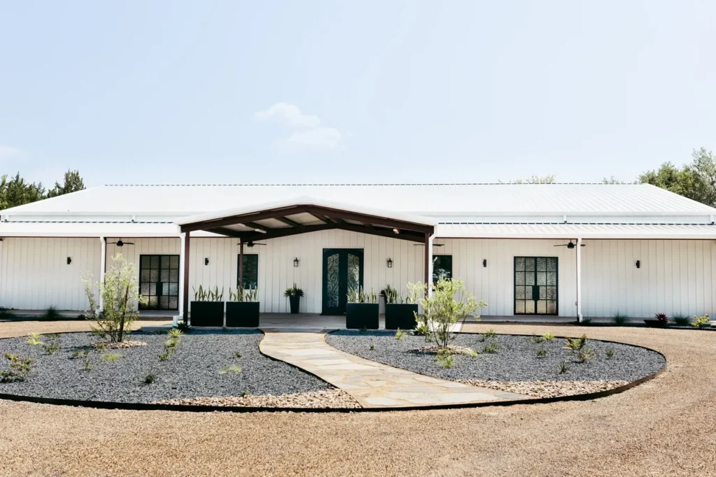White wedding venue with black doors near Dallas.