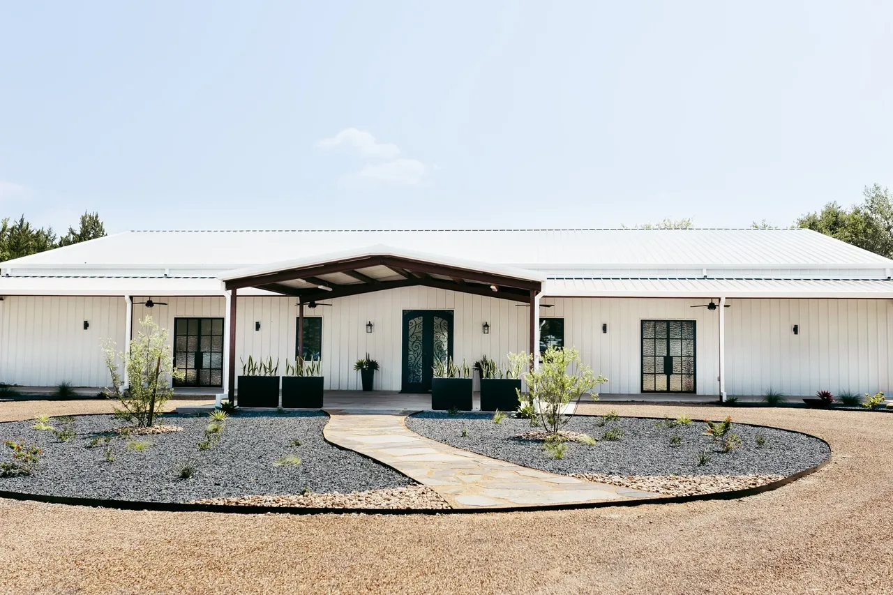 White wedding venue with black doors near Dallas.