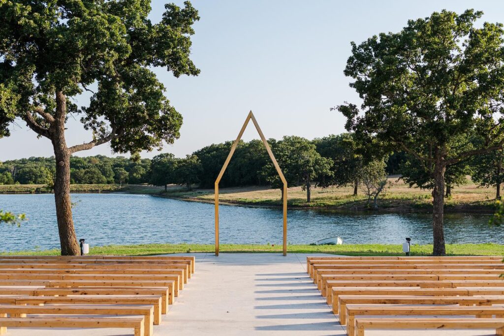 Wood Pews on the ceremony site of a lakefront wedding venue.