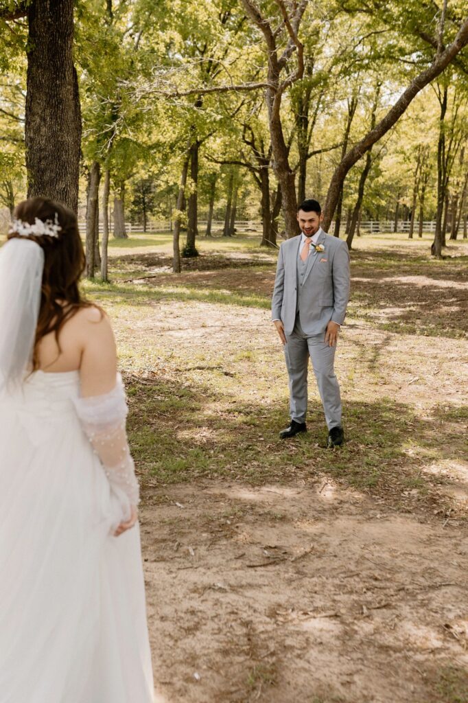 Grooms first look at the bride. Bride and groom first look at wedding venue in Corsicana Texas.