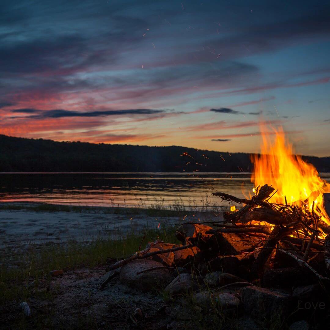 Fire by the lake at the wedding venue in Corsicana Texas. Wedding venue firepit.