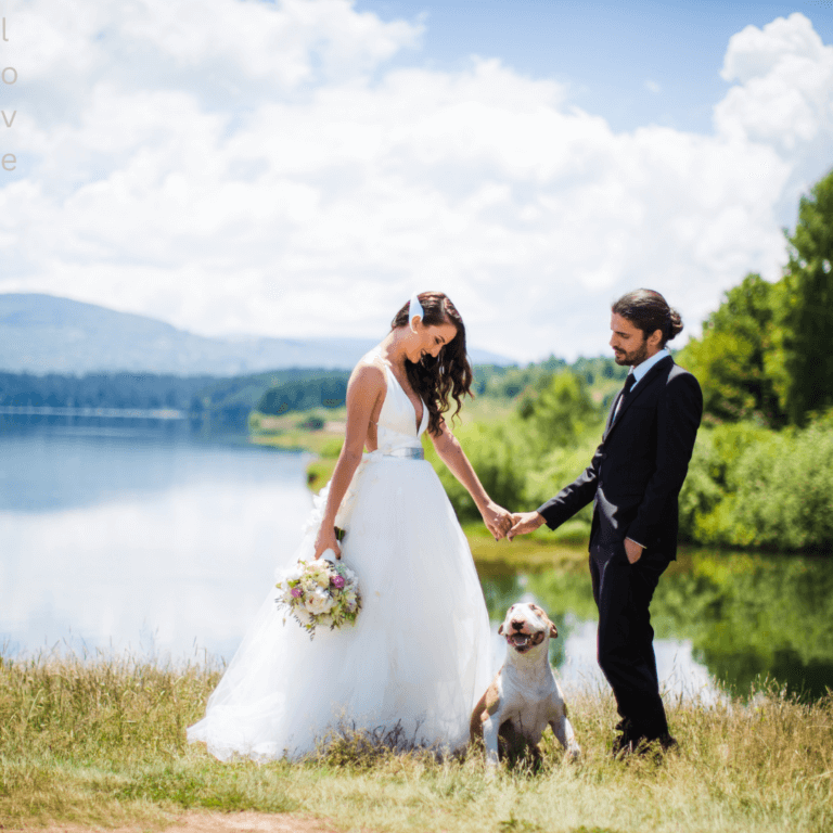 Bride and groom standing with their dog on the lakeshore at Lakefront Acres in Kerens, Texas—capturing a joyful waterfront wedding moment near Dallas and Corsicana.