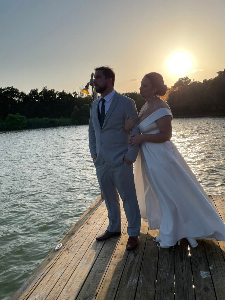 couple renewing vows at lakefront wedding venue in Texas at sun