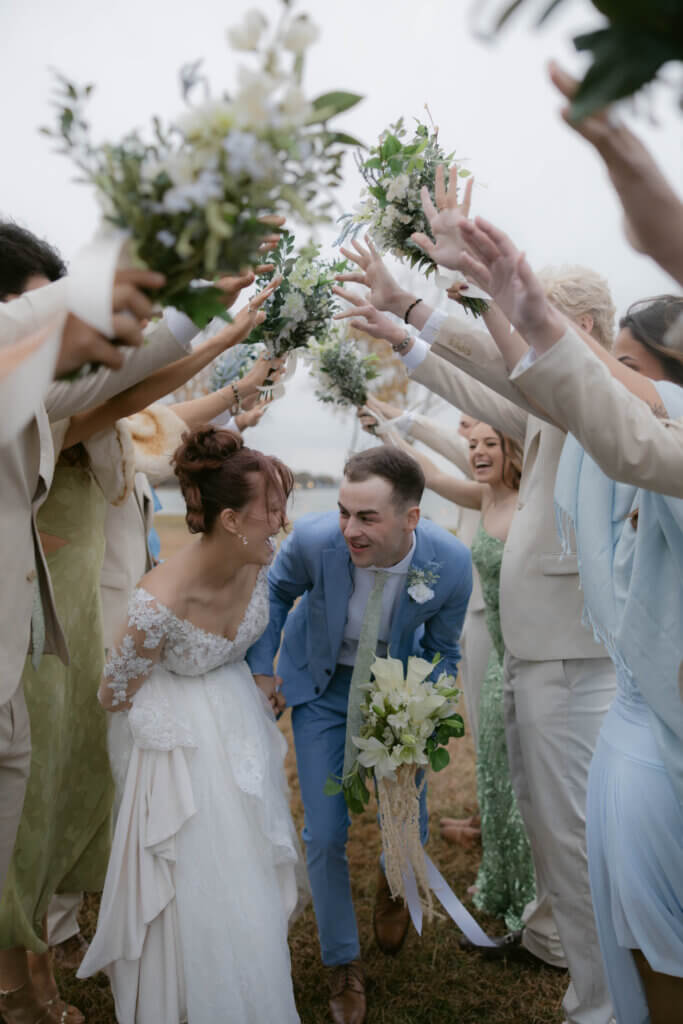 Bride and groom recreating a viral TikTok wedding entrance trend at a scenic lakeside wedding venue in Texas