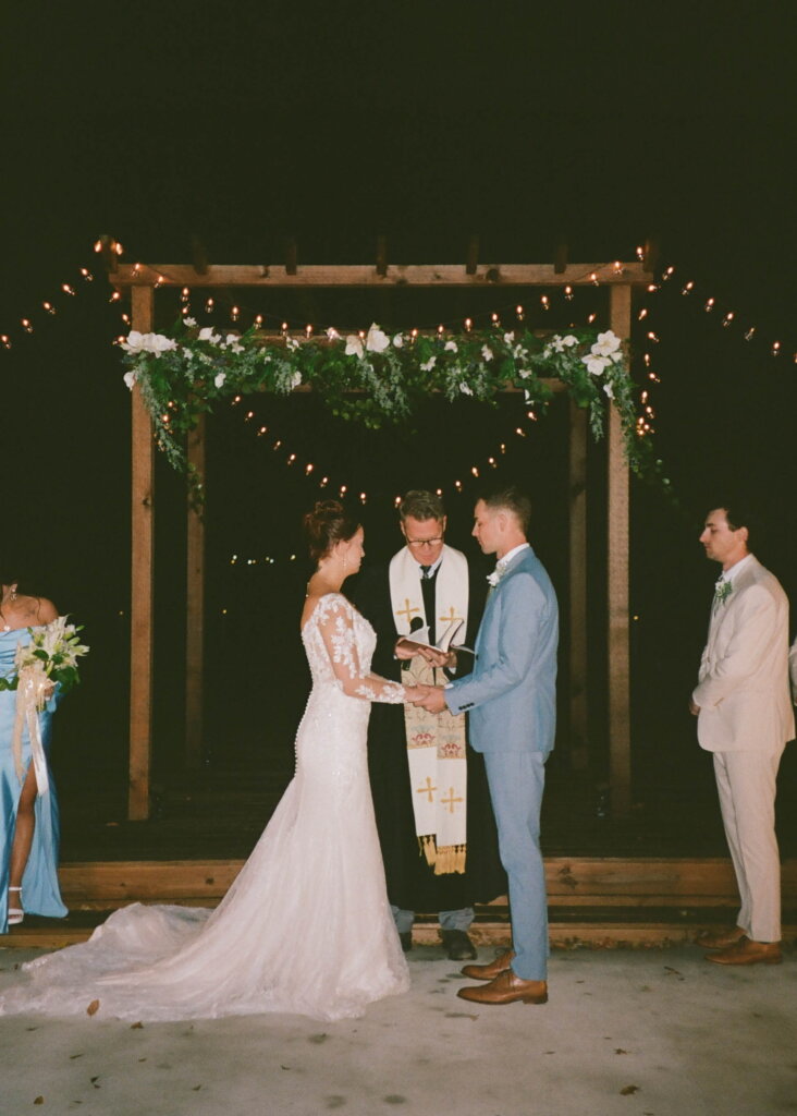Couple holding hands during vow renewal ceremony in Dallas.