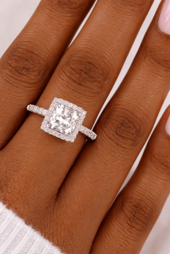 Princess cut diamond halo engagement ring on slender hand with French manicure – Texas bride style inspiration at Lakefront Acres Wedding Venue