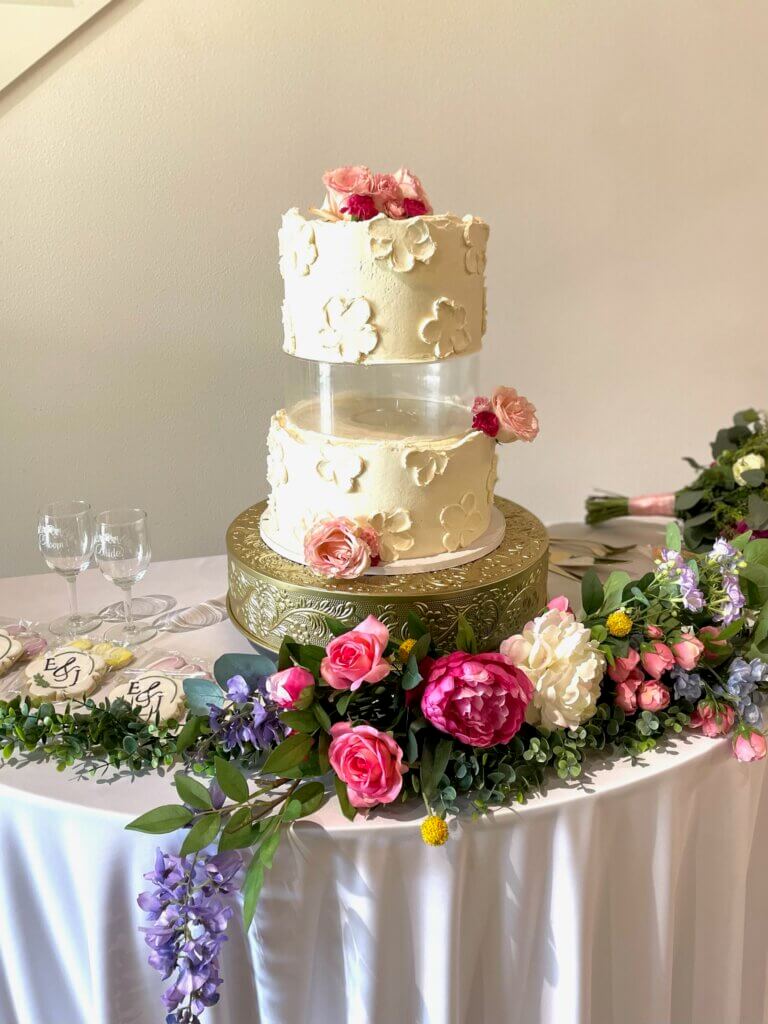 Rustic wedding reception tablescape with candles, florals, and elegant place settings at Lakefront Acres