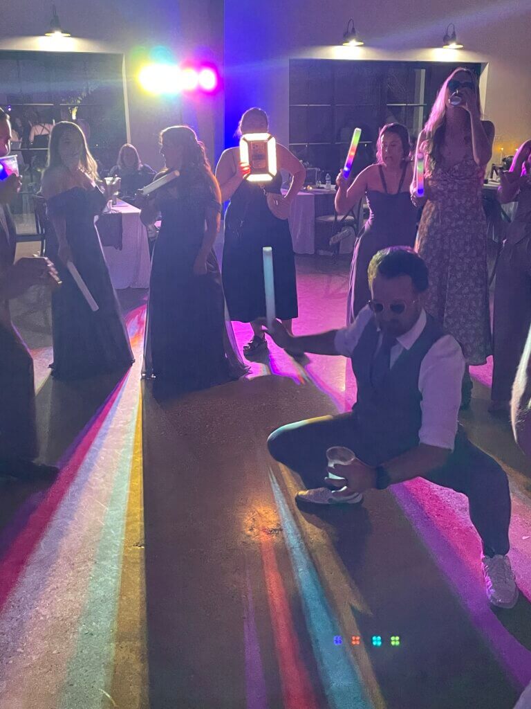 Guests dancing and celebrating at a joyful wedding reception at Lakefront Acres Wedding & Event Venue with laughter, music, and unforgettable memories under the lights.