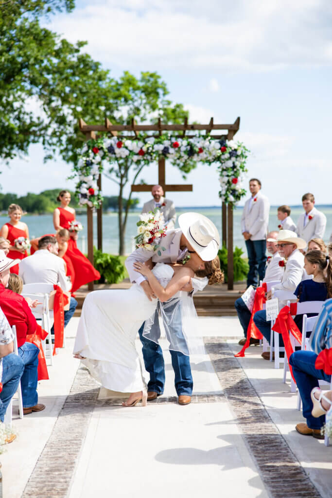 Newly married couple walking down the aisle after outdoor wedding ceremony