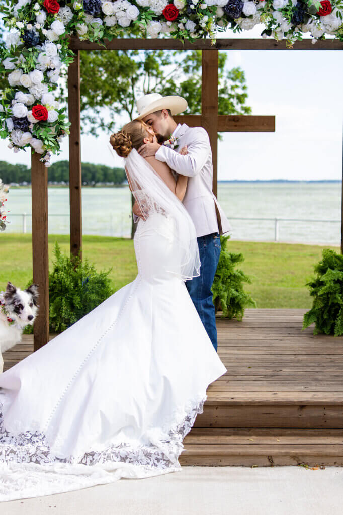 Couple exchanging vows during lakeside wedding ceremony in Texas
